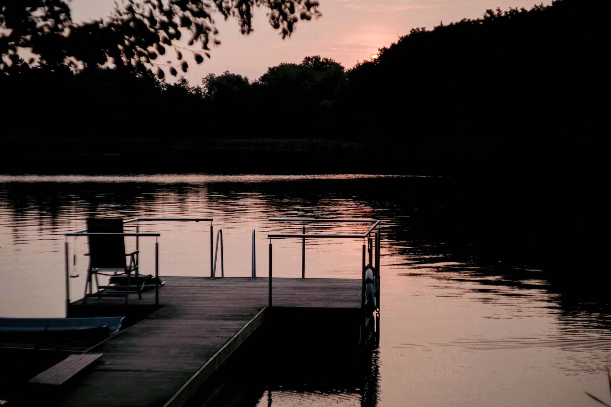 The dock at dusk, still water, the channel beyond.