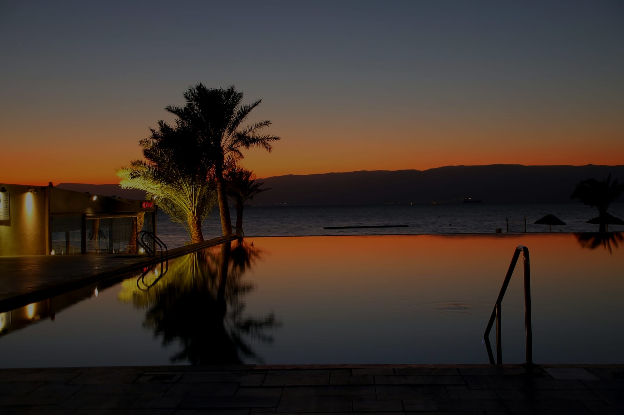 The terrace at dusk, vanishing-edge pool against the last of the west light.